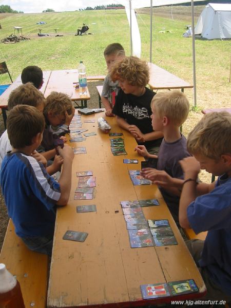 Die jüngeren Teilnehmer beschäftigen sich mit einem Kartenspiel